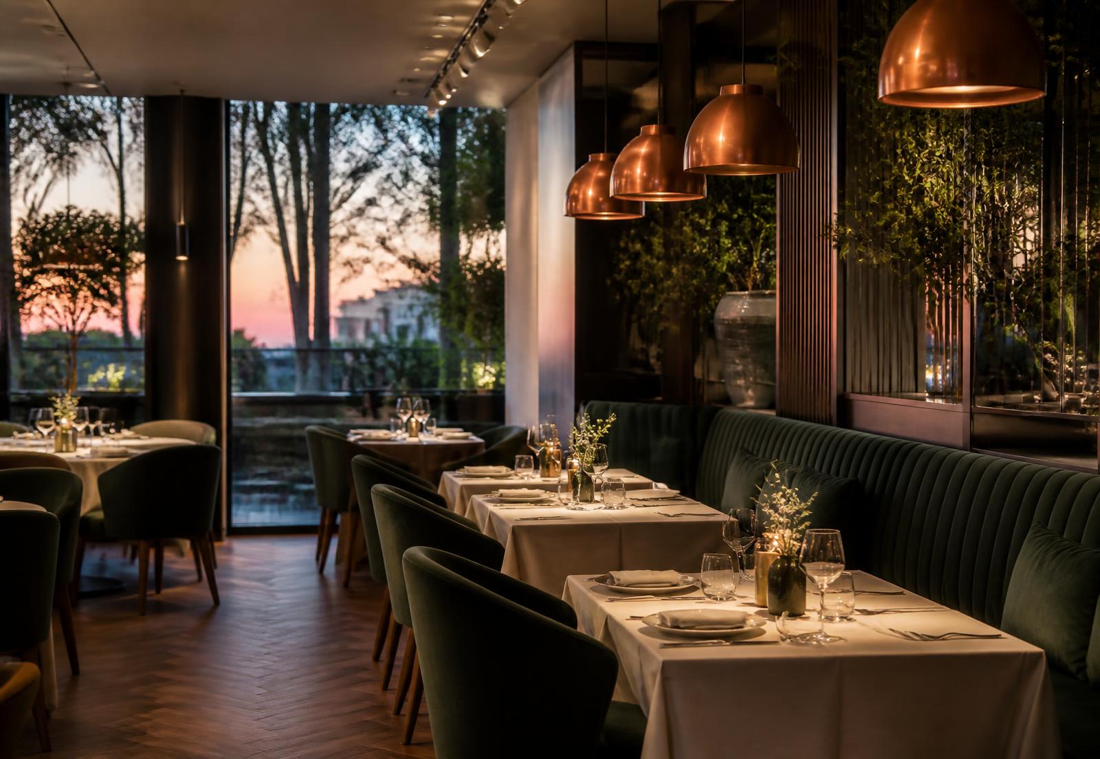 Warmly lit restaurant dining room with set tables